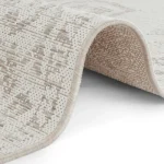 A close up of a section of an outdoor Carpet with a distressed vintage inspired pattern